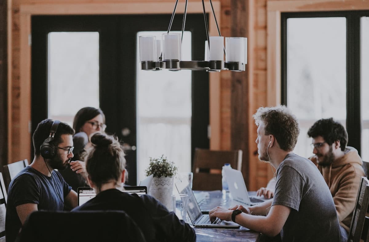 A small team collaborating around a shared workspace table