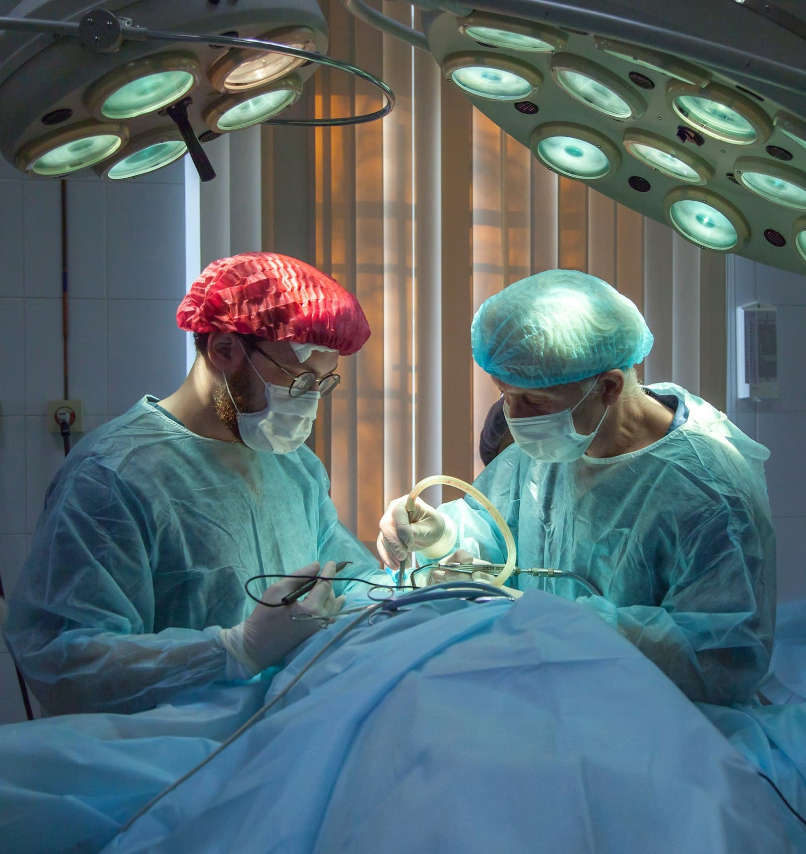 Two surgeons performing a procedure in an operating room