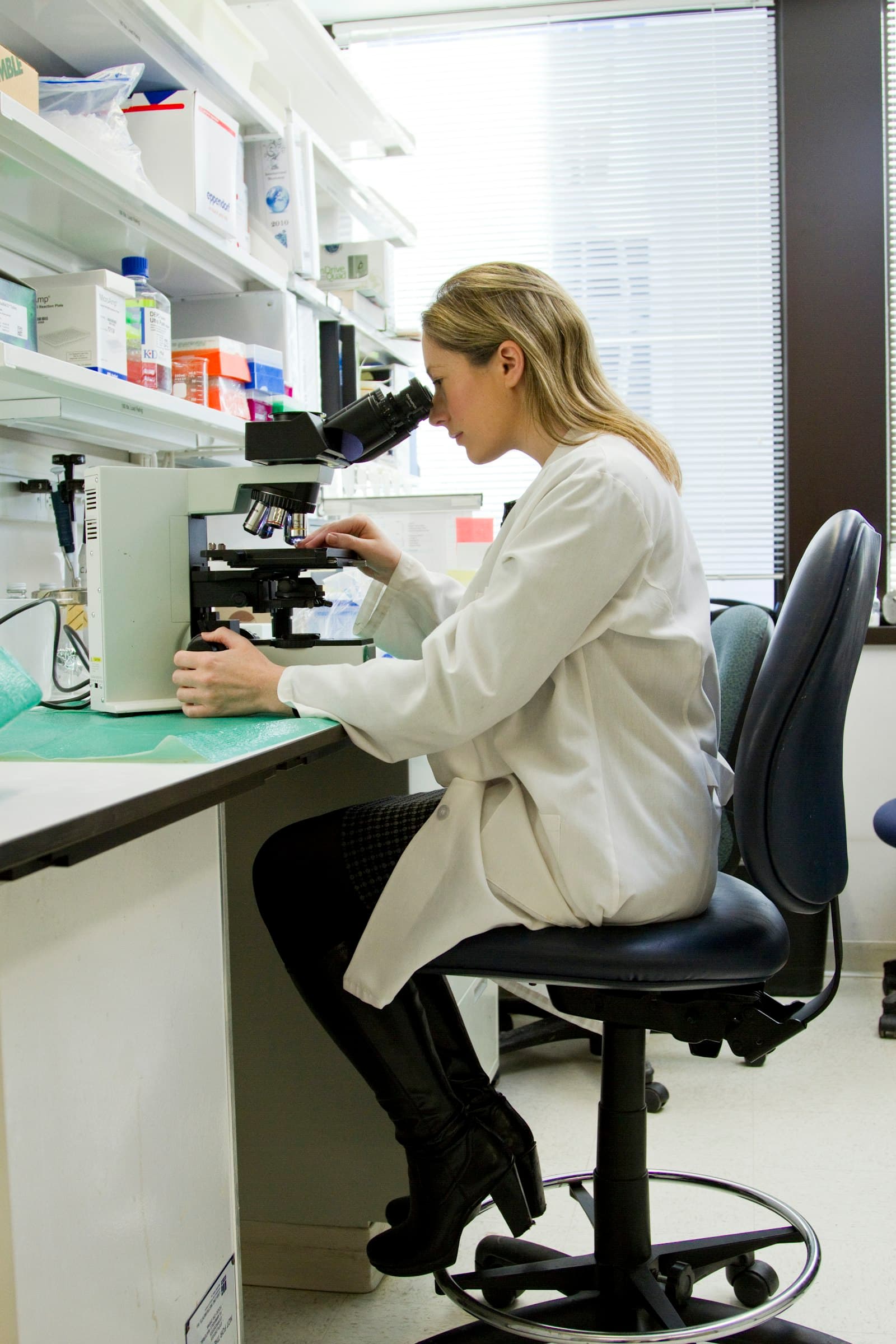 A researcher working at a microscope in a laboratory