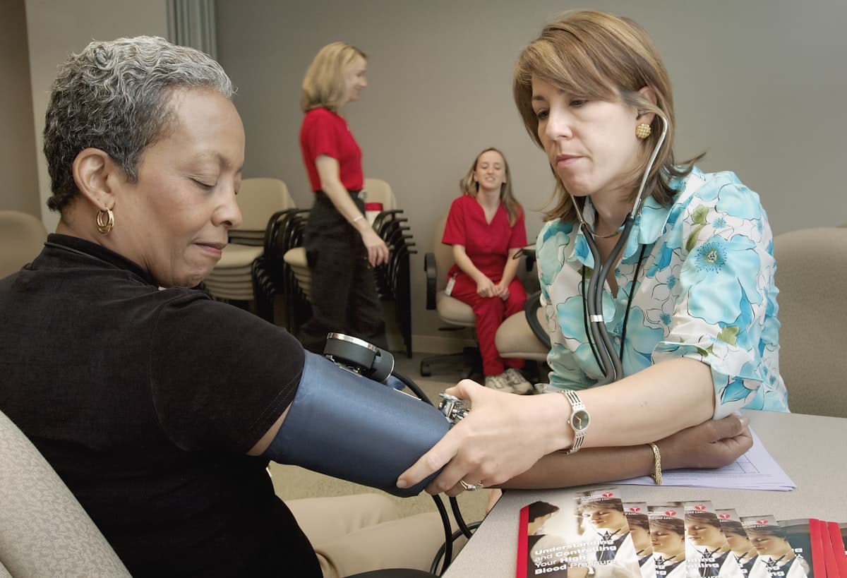 A nurse taking a patient’s blood pressure