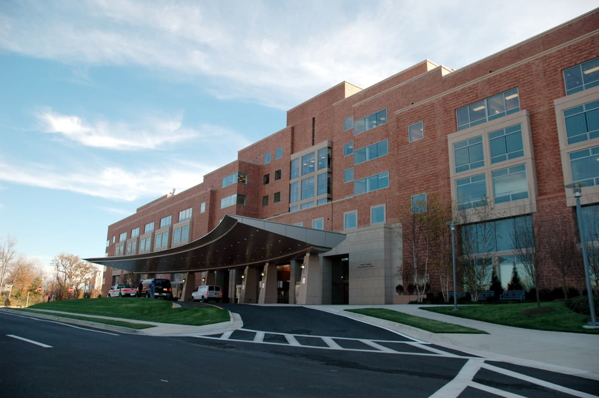 The brick exterior of a modern hospital with covered drop-off