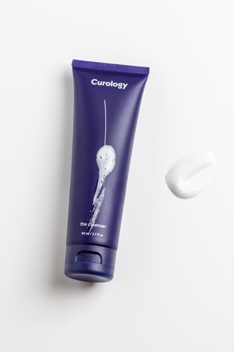 A skincare cleanser bottle, editorial flat lay