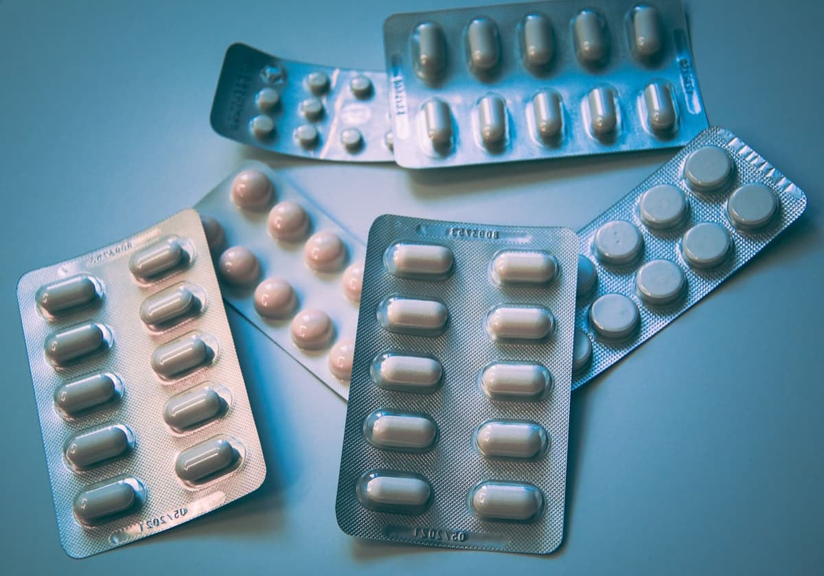 Pharmaceutical pill blister packs on a blue surface